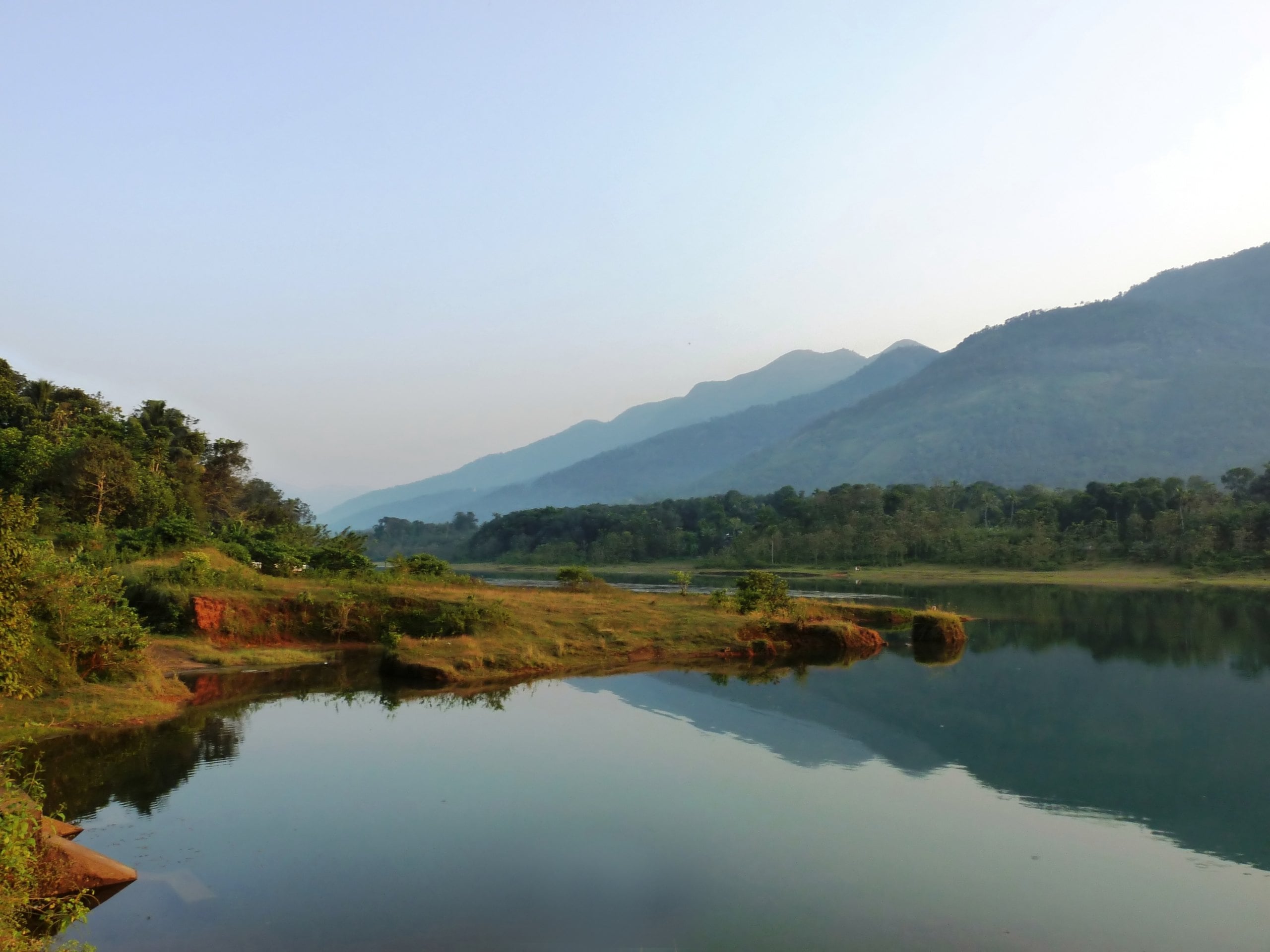 The Malankara reservoir from Kudayathoor, with hills reflected in still water