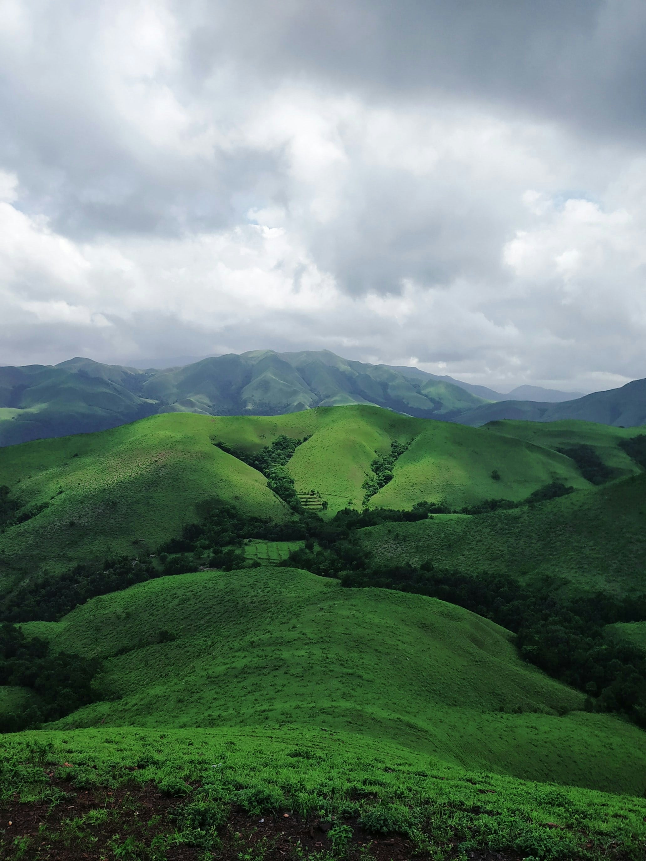 Rolling green hills beneath a cloudy sky